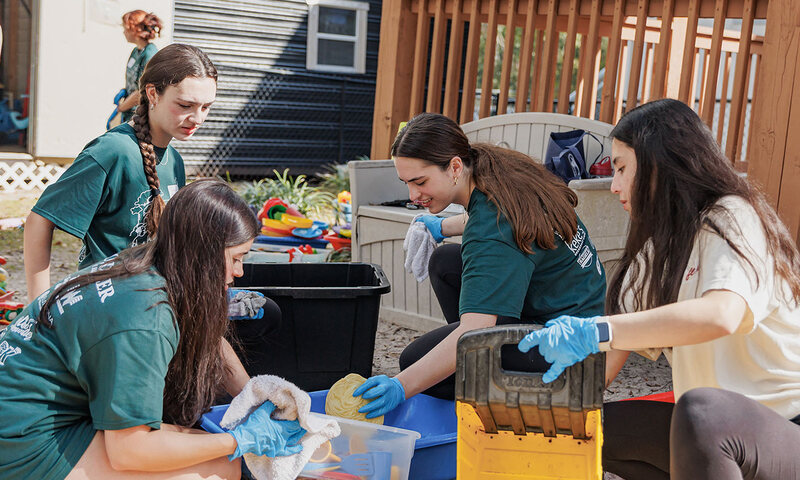 Volunteers sorting supplies during a spring cleanup project.